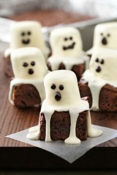 some brownies with white frosting and ghost faces on them