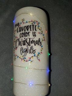 a white canister with christmas lights on the side and writing that says my favorite cook is christmas lights