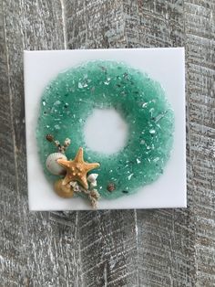 a sea glass wreath with starfish and seashells