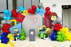 the entrance to an office decorated with balloons and paper cutouts for kids'birthdays