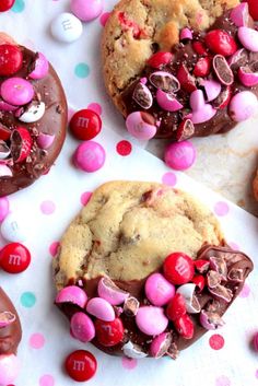 chocolate chip cookies with m & m candies and candy on the top one is half eaten