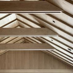 the interior of a building with wooden walls and beams on the ceiling is made of plywood planks