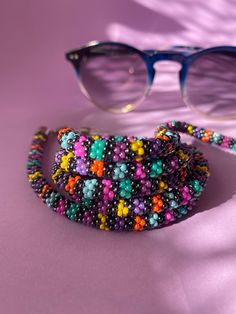 The perfect accessory for your wardrobe, adding a finishing touch to your outfit. Multi-functional glasses, sunglasses and mask chain holder with multi-colored beads. It can also be used as a necklace. Thank you in advance for choosing my designbycolla store. If you have a question, I can answer immediately. My three-functional product, which can be eyeglass chain, necklace, bracelet, is completely made with the help of handmade crochet. This eyeglass chain can be a very perfect choice for your Handmade Beaded Necklaces For Everyday Summer, Handmade Purple Beaded Necklace For Summer, Summer Handmade Purple Beaded Bracelets, Colorful Beads Glasses Chains As Summer Gift, Multicolor Beaded Chain Glasses Chains For Gifts, Multicolor Beaded Glasses Chain As Gift, Multicolor Beaded Glasses Chain For Gift, Summer Glasses Chains With Colorful Beads As Gift, Trendy Multicolor Glass Beaded Necklaces