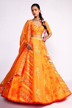 Orange attached can-can lehenga with floral print panels and geometric embroidered panels. Paired with a blouse with all over geometric and floral embroidery in sequins, beads, cutdana. Comes along with a dupatta.
Components: 3
Pattern: Embroidery
Type Of Work: Sequins, Cutdana, Beads
Neckline: Tear Drop Neck
Sleeve Type: Half Sleeves
Fabric: Lehenga and Blouse: Silk, Dupatta: Organza
Color: Orange
Other Details: 
Lehenga:
Attached can-can
Embroidered cascading tassels
Sequin embellished waistba Orange Organza Set For Festivals, Orange Organza Festival Set, Festival Orange Organza Set, Orange Lehenga For Festivals, Orange Sets With Sheer Dupatta For Navratri, Isha Gupta, Lehenga And Blouse, Orange Lehenga, Blouse Silk