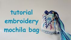 a small bag with tassels on it sitting next to the words, how to make a pattern for a bottom bottom mochila bag