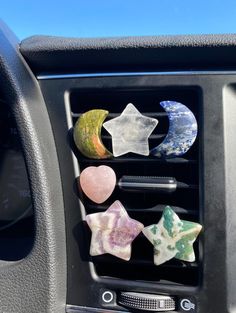 the car dashboard is filled with different colored rocks