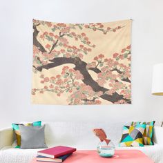 a living room with a couch, coffee table and wall tapestry hanging on the wall