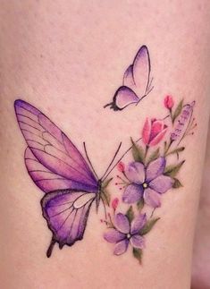 a tattoo with two butterflies and flowers on the side of her leg, one is purple