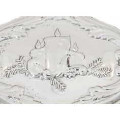 an ornate silver plate with a candle on it