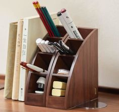 a wooden desk organizer with pens, pencils and other office supplies