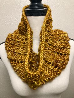 a mannequin wearing a yellow knitted scarf