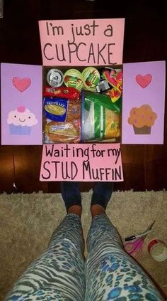 someone holding up a sign that says i'm just a cupcake waiting for my stud muffin