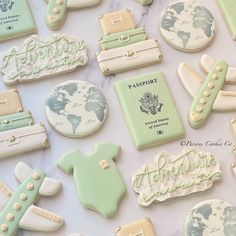 some cookies that are sitting on top of a white table with green and blue decorations