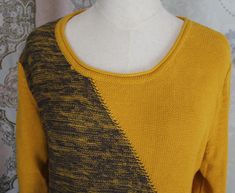 a mannequin wearing a yellow and black sweater