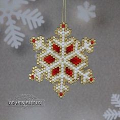 a beaded snowflake ornament hanging from a string