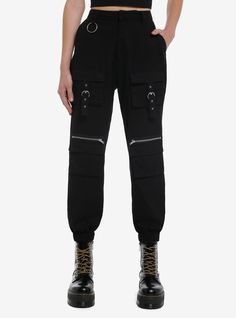 Baddies keep it edgy and casual. These black joggers are an essential to any wardrobe! They feature cargo pockets down the legs with zipper and grommet tape detailing. Complete with hip pockets  an O-ring accent on the belt loop and elasticated ankles.Please note: Style is fitted with no stretch; size up for a looser fit.100% cottonWash cold; dry lowRise: 14''Inseam: 27''ImportedListed in junior sizesModel is 5'10'' Black Pants With Metal Zipper For Fall, Utility Parachute Pants With Zipper For Streetwear, Trendy Black Pants With Metal Zipper, Trendy Streetwear Cargo Pants With Zipper Closure, Casual Black Bottoms With Metal Zipper, Trendy Streetwear Cargo Pants With Zipper, Trendy Black Bottoms With Metal Zipper, Fall Black Pants With Metal Zipper, Techwear Cargo Pants With Zipper For Streetwear