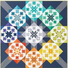 an image of a quilt made with many different colors and shapes on the same block