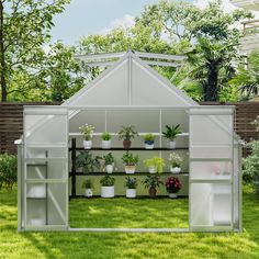 a white greenhouse with potted plants in it