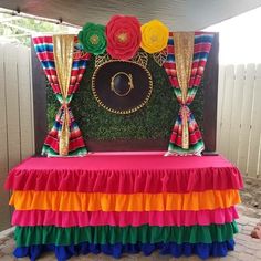 a colorful table with flowers on it and a sign in the middle that says o