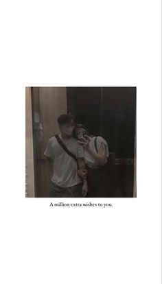 a man holding a baby in his arms while standing next to a bathroom mirror with the caption, a million extra wishes to you