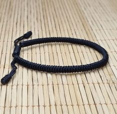 "◾ The handmade black Tibetan bracelet for luck and protection is a beautifully crafted accessory, each knot is meticulously tied whos creates an amazing pattern. ✅ Adjustable bracelet - the slip knot lets you adjust the size. ➰ Sizes: S - Fully Closed - 5.9\"inches (15cm) / Full Opened - 9.8\"inches (25cm) M - Fully Closed - 6.6\"inches (17cm) / Full Opened - 10.6\"inches (27cm) L - Fully Closed - 7.4\"inches (19cm) / Full Opened - 11.4\"inches (29cm) ⬛ The color of the bracelet is black. ◽ More colors and models are available in the shop. ◽ Just check out the shop. ✔️ Please note that due to the difference between different monitors, the image may not reflect the actual color of the item. ✍ If you have any questions please contact me." Handmade Adjustable Nylon Thread Bracelets, Handmade Adjustable Nylon Thread Bracelet, Handmade Black Nylon Cord Bracelets, Resizable Nylon Cord Braided Bracelets, Handmade Black Paracord Braided Bracelet, Handmade Minimalist Bracelets With Nylon Cord, Snake Knot Bracelet, Bracelet For Him, Snake Knot