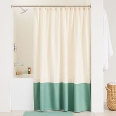 a bathroom with a shower curtain and rug on the floor