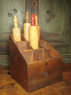 an old wooden box with some knives in it