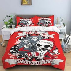 a bed with red comforter and two pillows