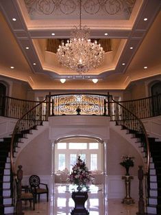 a large foyer with chandelier and stairs