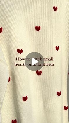 a white sweater with red hearts on it that says how to teach small hearts on knitwear