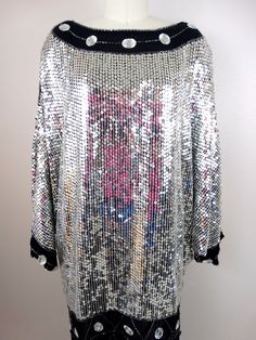 "This beautiful vintage piece fully embellished with reflective mirror silver sequins and jewels on silk and fully lined. It's in excellent condition! (note, I was wearing a pink shirt while photographing and the color reflects in the sequins) Bust - 58\" Waist - 44\" Hips - 42\" Length - 34\" All of my items come from a smoke-free and pet-free home. If you have any questions, please don't hesitate to ask!" Fitted Silver Dress With Mirror Work, Disco Style Embellished Sequin Fabric For Party Season, Silver Embellished Sequin Fabric For Night Out, Disco Style Embellished Sequin Fabric For Evening, Metallic Embellished Sequin Dress For Cocktail, Holiday Metallic Embellished Sequin Dress, Disco Style Embellished Sequin Cocktail Dress, Glamorous Embellished Metallic Sequin Fabric, Embellished Sequin Dress For Costume Party And Holiday