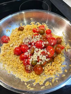 tomatoes and cheese are mixed together in a bowl on the stove top, ready to be cooked