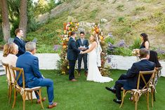 a bride and groom are getting married in the grass at their backyard wedding ceremony,