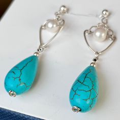 Enjoy the beauty of Natural Spiderweb Turquoise teardrop sterling silver earrings. These stunning, elegant and stylish earrings are mounted on solid 925 Sterling Silver ball stud with butterfly closure. Known for its intense blue color with little to no matrix, it makes jewelry of incredible beauty and value! The Turquoise earrings are complimented with a 6 mm Freshwater pearl that adds class to every outfit! Natural Turquoise earrings will make a unique gift for anyone's birthday, anniversary o Elegant Turquoise Teardrop Pierced Earrings, Elegant Handmade Turquoise Teardrop Earrings, Turquoise Sterling Silver Teardrop Dangle Earrings, Turquoise Teardrop Pearl Drop Earrings, Elegant Turquoise Drop Teardrop Earrings, Elegant Turquoise Teardrop Earrings, Hypoallergenic Turquoise Sterling Silver Teardrop Earrings, Hypoallergenic Turquoise Teardrop Earrings In Sterling Silver, Elegant Turquoise Teardrop Earrings As Gift