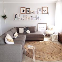 a living room filled with furniture and pictures on the wall