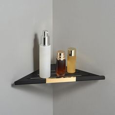 a shelf with two bottles on it next to a wall mounted soap dispenser