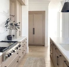 a kitchen with white counter tops and wooden cabinets