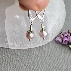 "✦These dainty earrings are a perfect little girl gift for a Daddy's gift or for a woman for everyday wear.  They are lightweight and easy to wear! ✦Small, dainty round-shaped natural pink freshwater pearl, 6mm in diameter, with sterling silver flower bead caps. ✦Ear wires: The oxidized silver version comes with stainless surgical steel lever back ear wires and the bright silver pair comes with sterling silver ear wires. Please select bright silver or oxidized silver at check out. ✦The total length is about 1 inch.  ✦Your jewelry will be packaged in a beautiful and reusable organza bag. All items will be placed in the same organza bag. If you need a separate bag for each item, please leave a comment at check out. ✦Giving your purchase as a gift? If you would prefer that prices not be print Adjustable Lever Back Jewelry Gift, Adjustable Lever Back Jewelry As A Gift, Tiny Elegant Pearl Earrings For Gifts, Dainty Lever Back Earrings As Gift, Delicate Pink Pearl Earrings For Gift, Delicate Pink Pearl Earrings As Gift, Nickel-free Adjustable Pearl Earrings For Everyday, Delicate Silver Pearl Earrings Hypoallergenic, Delicate Pearl Earrings As Gift