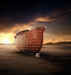 a large boat sitting on top of a sandy beach under a cloudy sky at sunset