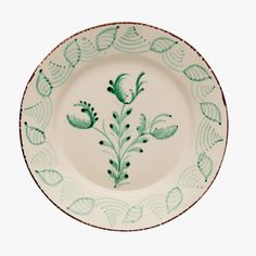 a green and white plate with leaves on it