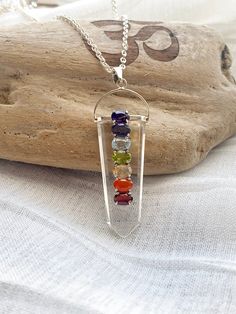 7 Chakra Gemstones on Crystal point pendant make this piece of jewelry is very special. All 925 sterling silver and raw gemstone. This necklace is designed with seven different gemstones, each symbolizing the seven energy points in your body. Each of the gemstones has its healing powers and is believed to render physical, mental, and spiritual benefits. ** Onyx Chakra pendant measures approx. 62mmx 20mm ** Crystal Chakra pendant measures approx. 50mm~ 60mm x 20mm (all crystal pendant sizes varie Healing Crystal Necklace With Natural Stones, Crystal Necklaces With Natural Stones For Healing, Healing Crystal Necklaces, Natural Stone Pendant Crystal Necklace, Spiritual Crystal Necklace With Natural Stones, Pendant Crystal Necklace With Mineral Stones, Crystal Pendant Necklace With Natural Stones, Mineral Crystal Pendant Necklace With Stones, Quartz Gemstone Pendant Crystal Necklace