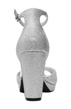 Sparkling crystals bring occasion-ready appeal to a platform sandal fashioned with an adjustable strap at the ankle. 2 1/2" heel; 1/2" platform Adjustable ankle strap with buckle closure iFlex technology provides 90-degree bend for superior comfort and flexibility Synthetic upper, lining and sole Imported