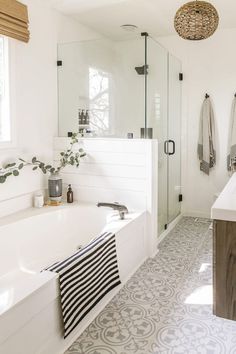 a white bathroom with black and white decor