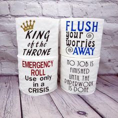 two toilet paper rolls with words on them sitting next to each other in front of a brick wall