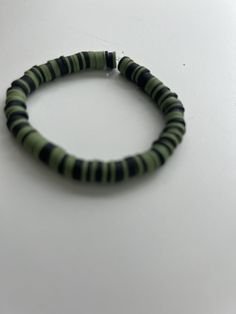 Green and black clay bead bracelet Green And Black Bracelet, Clay Bead Bracelet Ideas For Men, Black Heishi Beads Bracelet, Black Heishi Beads Beaded Bracelets, Black Heishi Beads Jewelry For Friendship, Black Beaded Friendship Bangle Bracelet, Black Beaded Bangle Bracelets For Friendship, Black Beaded Bracelet With Round Beads, Adjustable Black Heishi Beads Stretch Bracelet