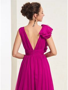 the back of a woman wearing a purple dress with ruffles on her shoulders