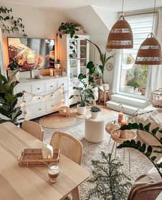 a living room filled with furniture and plants