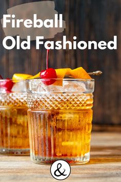 two glasses filled with liquid and fruit on top of a wooden table next to each other