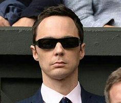 a man wearing sunglasses and a suit