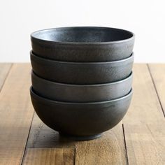 four black bowls stacked on top of each other